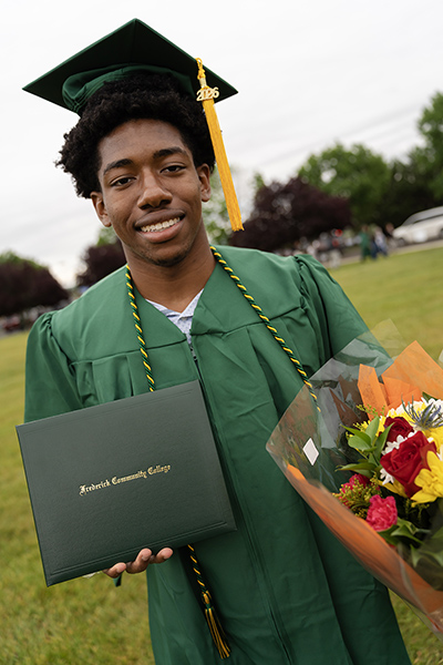 A group of graduates in caps and gowns celebrating together during the ceremony
