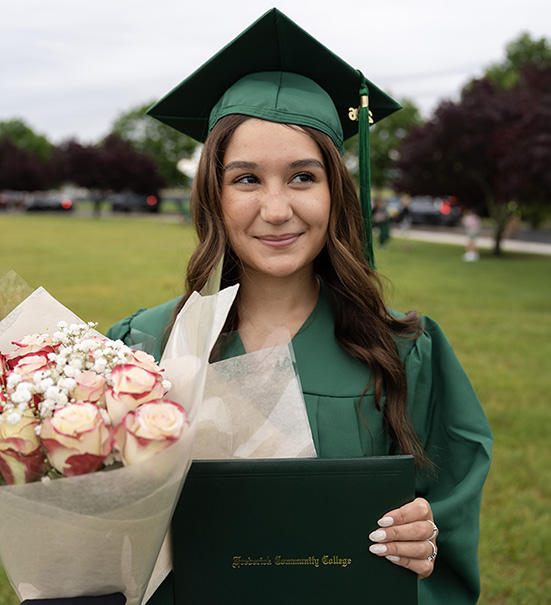 A graduate tossing their cap into the air at the end of the ceremony