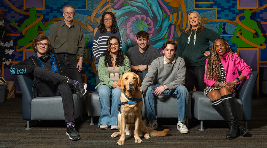 People in Mosaic Center with Diggy the dog