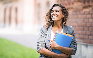 Girl holding notebooks