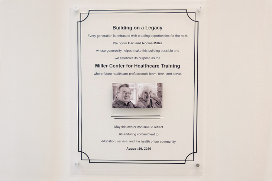 Dedication plaque titled "Building on a Legacy," honoring Carl and Norma Miller for the Miller Center for Healthcare Training, dated August 20, 2026.